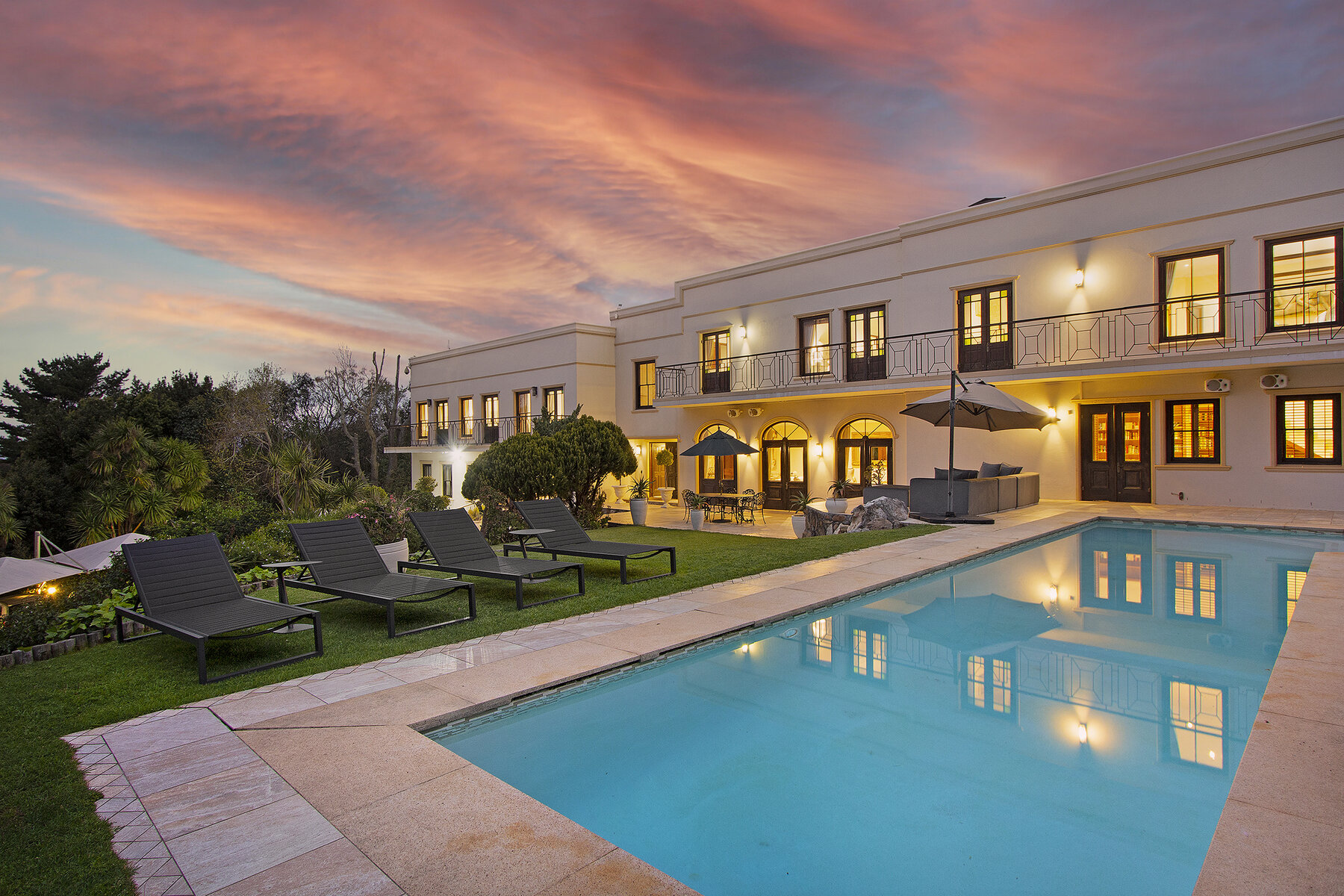 Lyonesse House at dusk, overlooking its heated pool